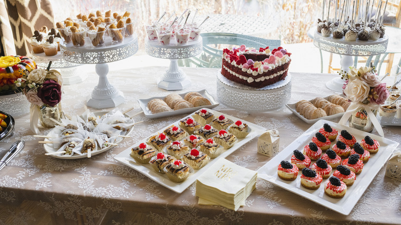A table full of mixed pastries and cakes