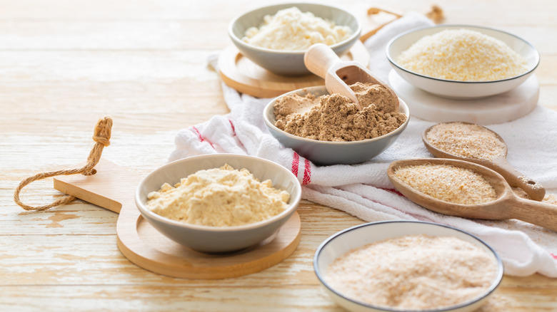 An assortment of various flours in bowls