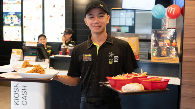 McDonald's worker carrying trays of food