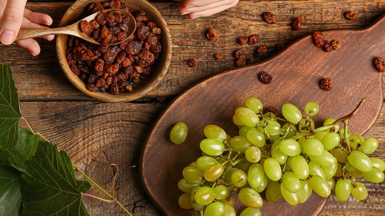 bowl of raisins and tray of grapes