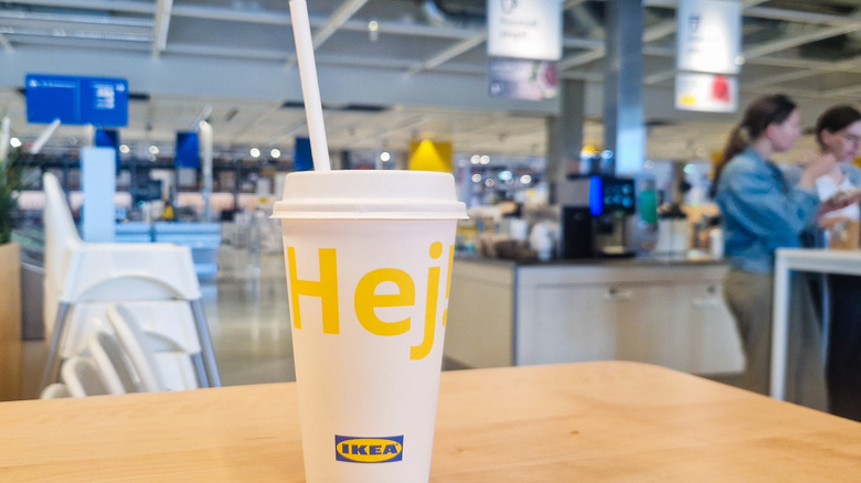 A fountain drink with Ikea food court in background
