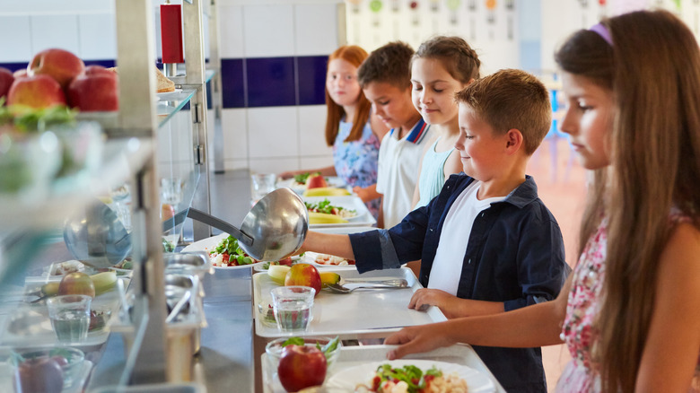 kids lining up for food in cafeteria