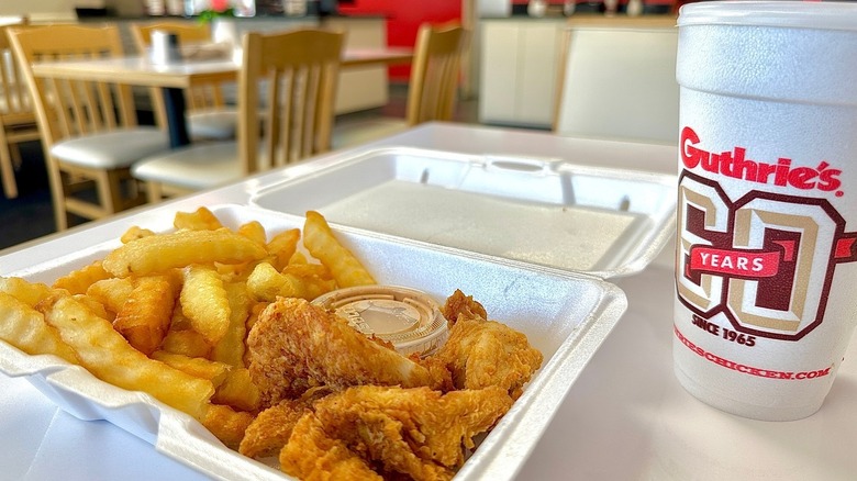 A Guthrie's combo platter with fries and chicken, with a dip and a large drink