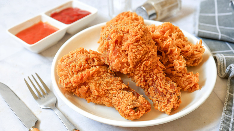 Golden brown fried chicken on a white plate