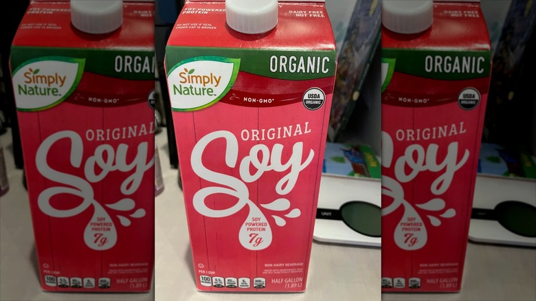 A carton of Aldi's soy milk sits on a kitchen counter