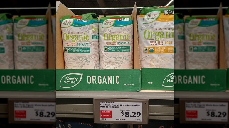 Bags of Simply Nature coffee on an Aldi shelf with a $8.29 price label