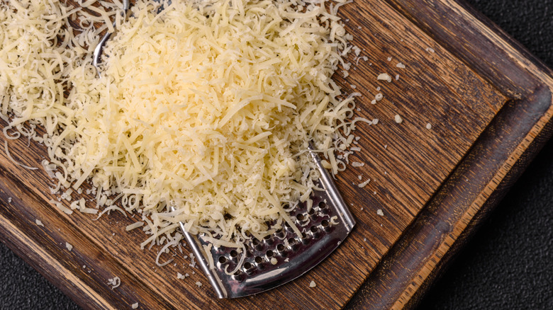 Shredded parmesan cheese on a cutting board