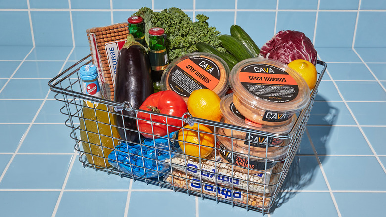 basket of groceries with Cava spicy hummus