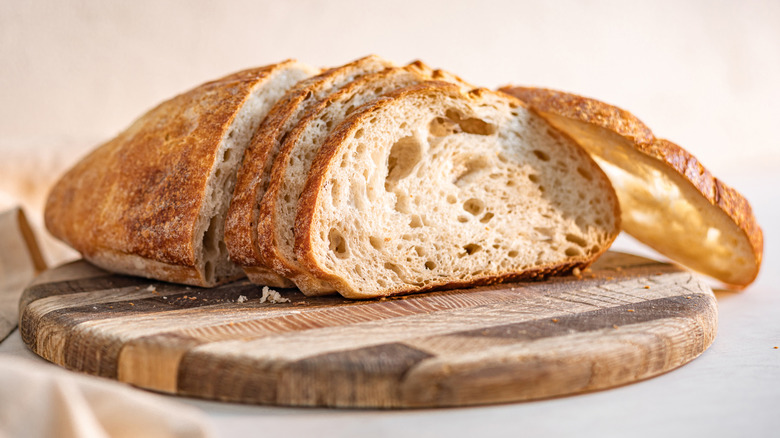 Sourdough loaf pictured on cutting board.