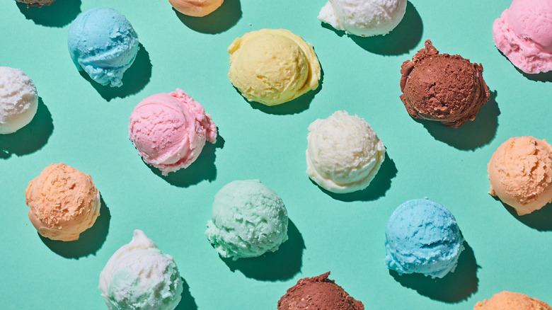 Assorted ice cream scoops on turquoise background