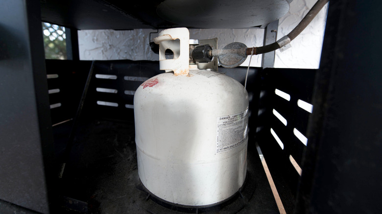 A propane tank in a grill.