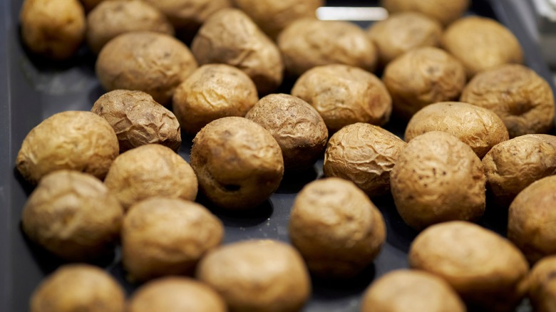 many potatoes on a baking sheet