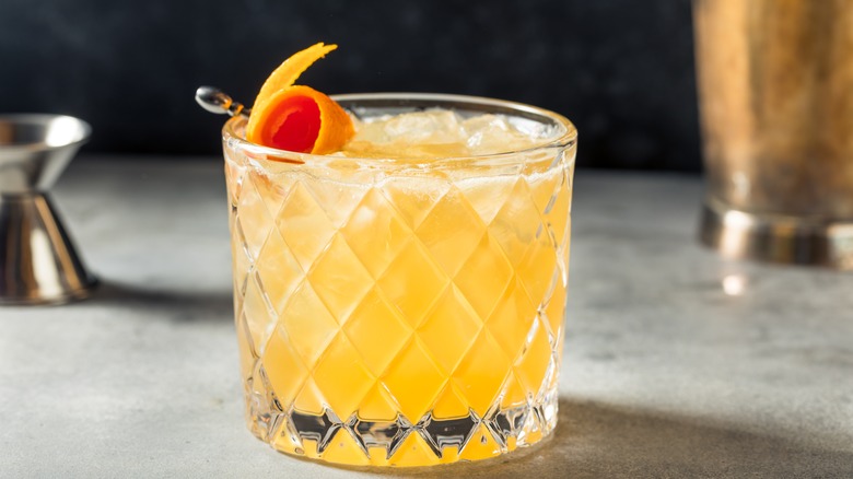 Whiskey sour with classic orange peel garnish