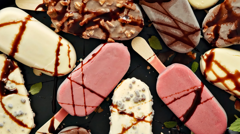 Assorted ice cream bars on a black surface