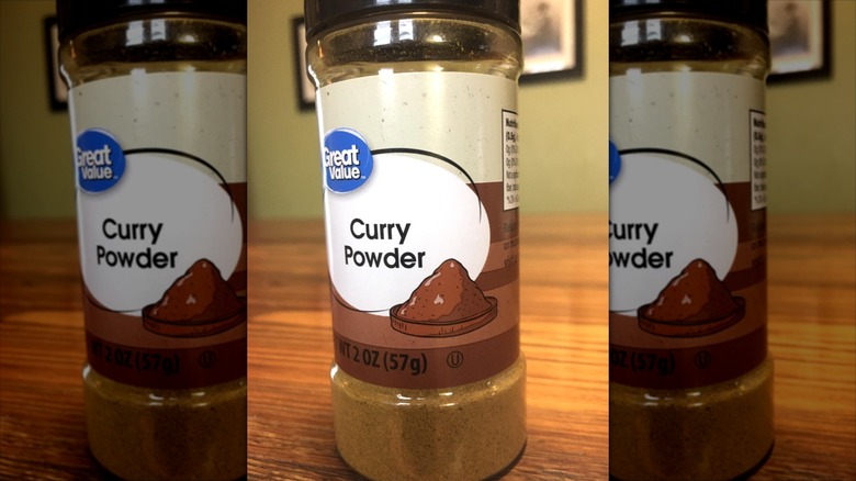 A container of Great Value curry powder sits on a table