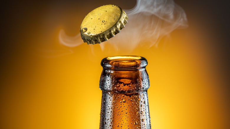 Open bottle of beer with cap off