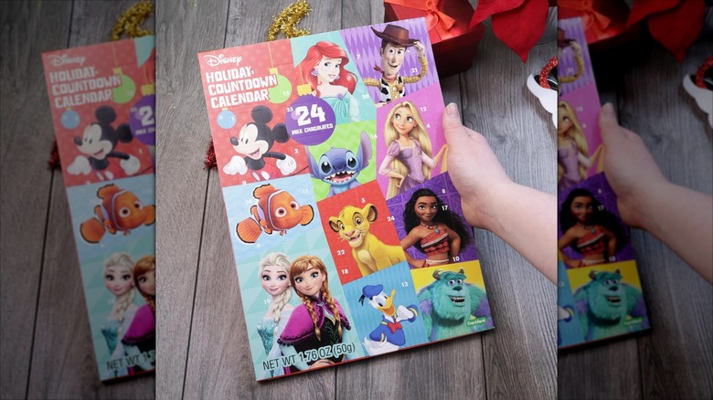 A hand holds a Disney Holiday Countdown Calendar