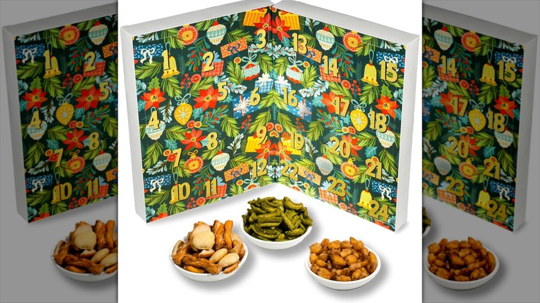 A 24 Days of Nuts & Snacks advent calendar sits propped open, with three snack servings sitting in front of it