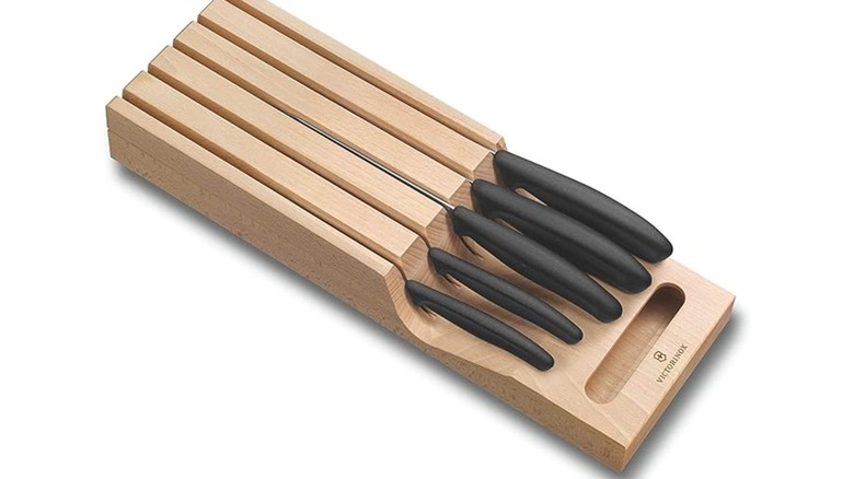 A victorinox knife set in a wooden organizer