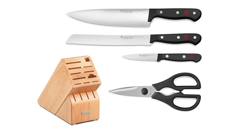Three knives, one pair of shears and a block