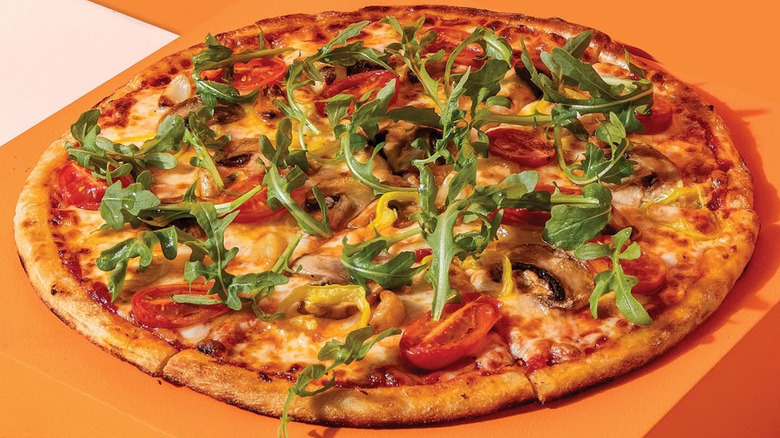 A Blaze Pizza with several toppings.