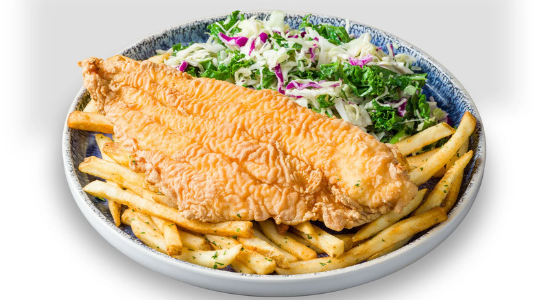 Big slab of fried catfish atop fries and kaleslaw from California Fish Grill.
