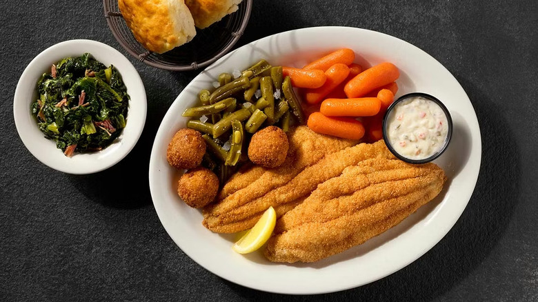 Fried catfish meal with hushpuppies, green beans, carrots, tartar sauce, salad, and biscuits from Cracker Barrel.