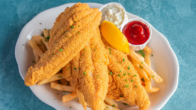 Fried catfish flittets with fries, ketchup, and tartar sauce from Pappadeaux Seafood Kitchen.