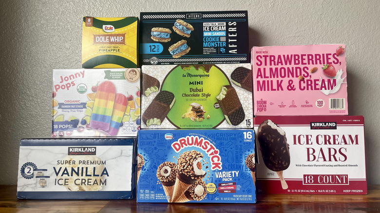 Collection of Costco frozen desserts in their boxes and stacked on a wooden tabletop