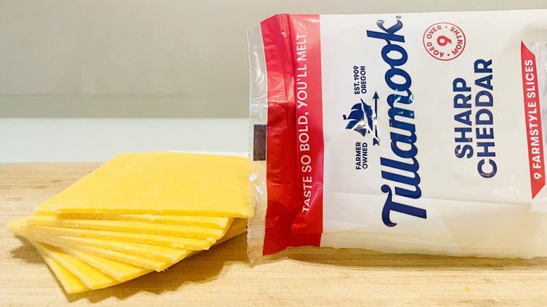 Stack of Tillamook Sharp Cheddar Cheese with packaging