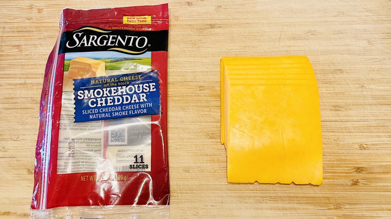 Package of Sargento Smokehouse Cheddar Cheese with grilled cheese sandwich