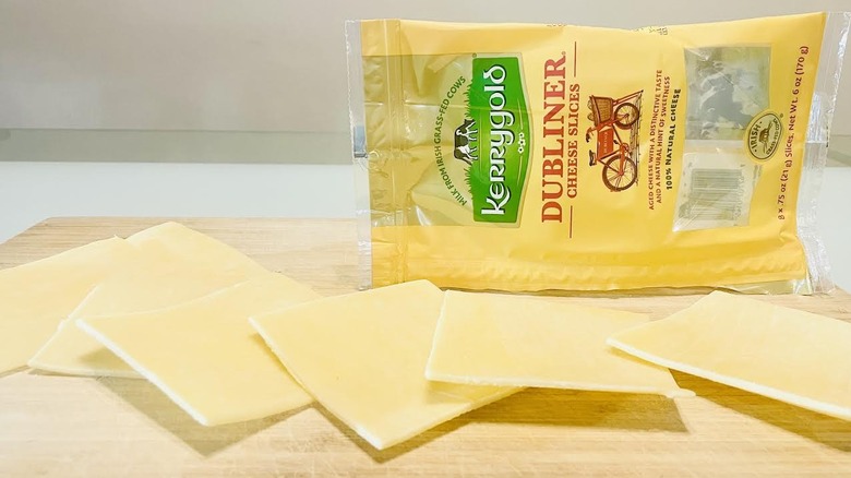 Slices of Kerrygold Dubliner Cheddar Cheese with packaging