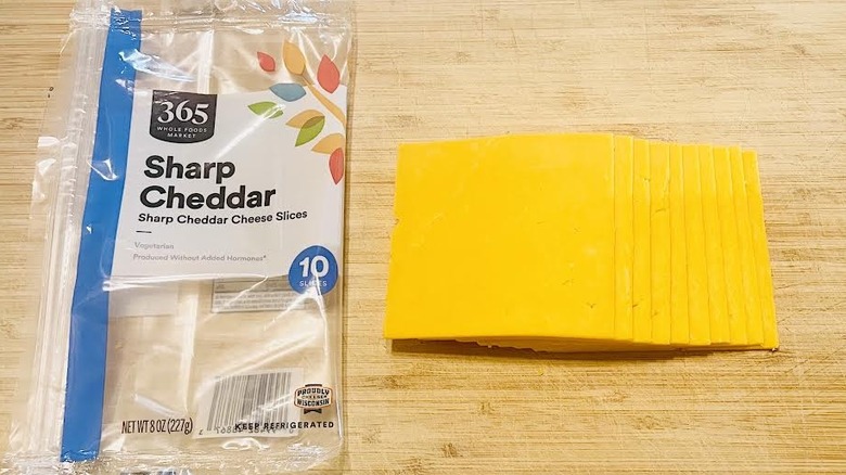 Sliced 365 by Whole Foods Market Sharp Cheddar Cheese with packaging