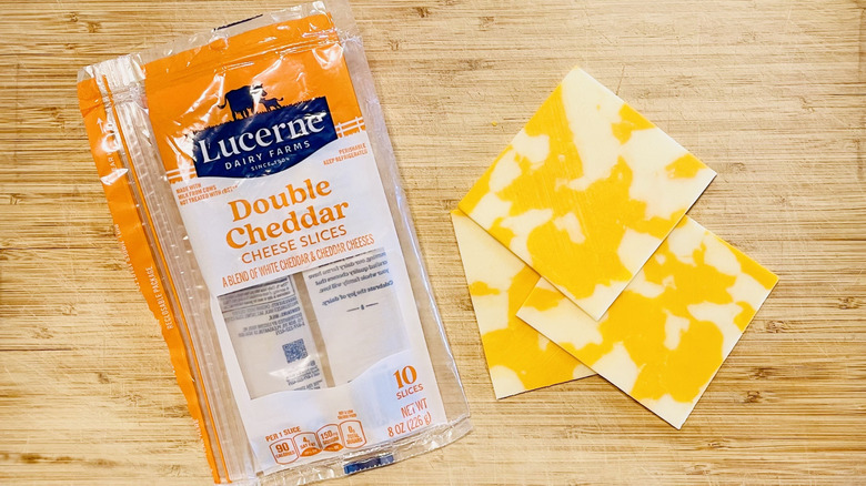 Package of Lucerne Dairy Farms Double Cheddar Cheese with grilled cheese sandwich