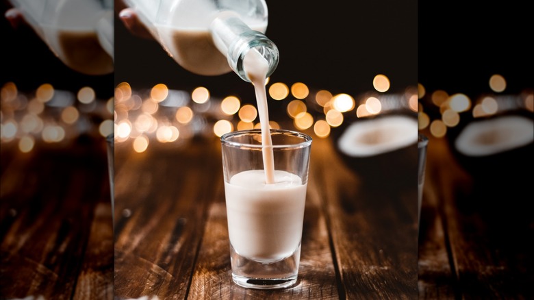 Bottle of coquito poured into glass