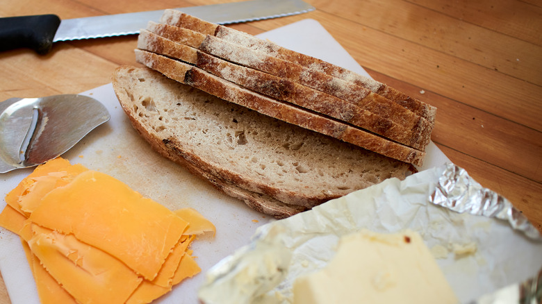 Sliced sourdough bread with butter and sliced cheese