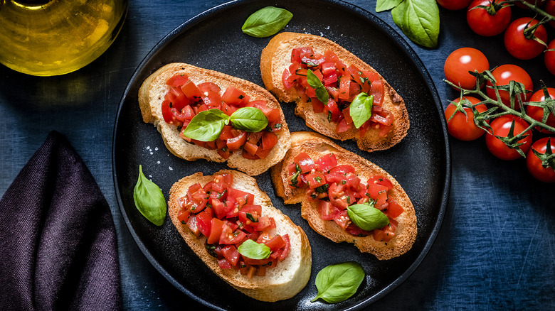 Bruschetta with tomatoes and basil on plate