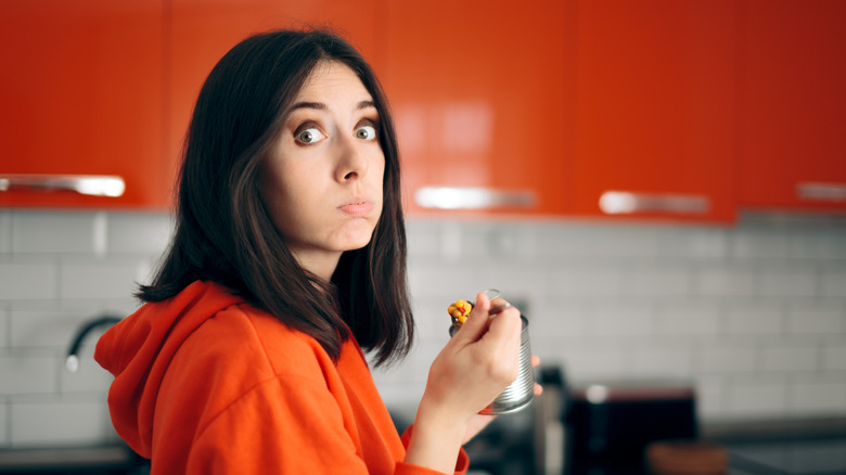 woman eating from a can