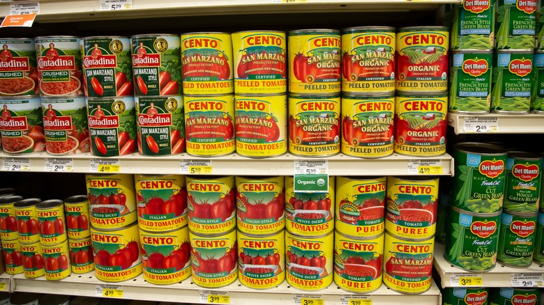 A shelf of canned tomatoes at the grocery store with Cento tomatoes front and center