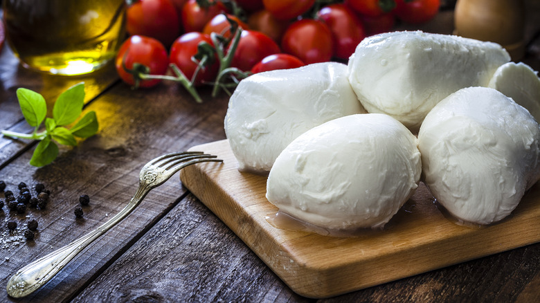 fresh mozzarella on a cutting board with fork