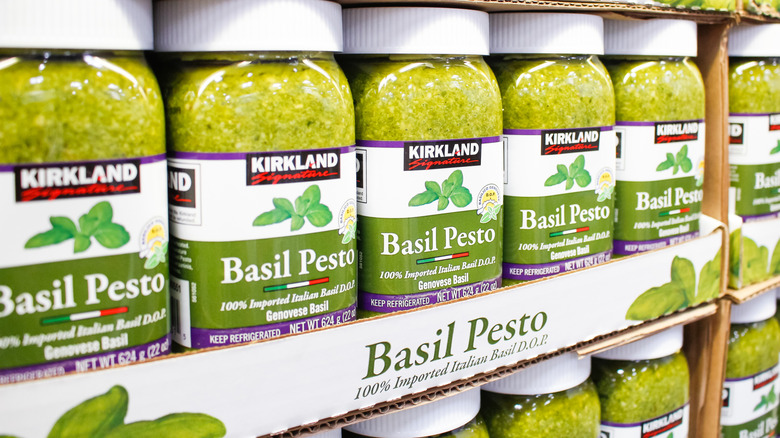 Jars of Kirkland Signature Pesto on display inside Costco
