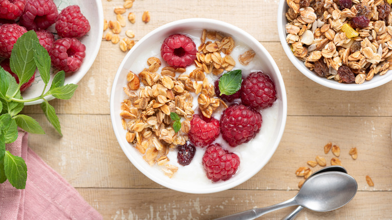 A granola bowl filled with strawberries.