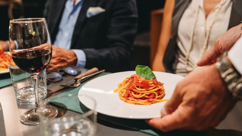 Diners served pasta at Italian restaurant