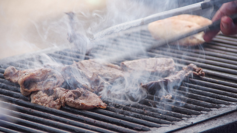 Cooking skirt steak for carne asada on hot grill.