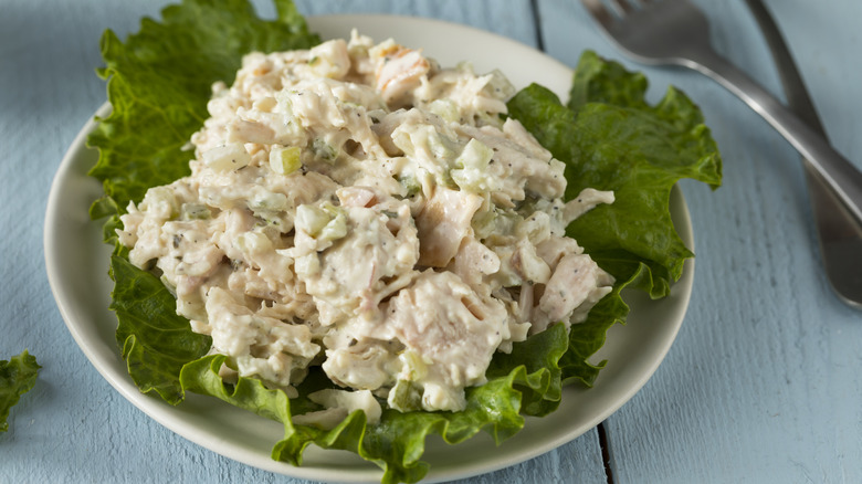 creamy chicken salad on a bed of lettuce