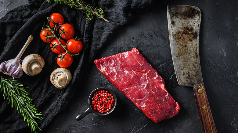 raw flank steak black background