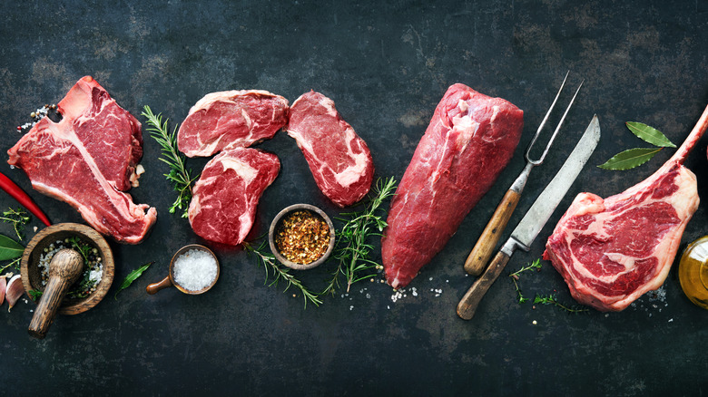 raw cuts of steak on slate