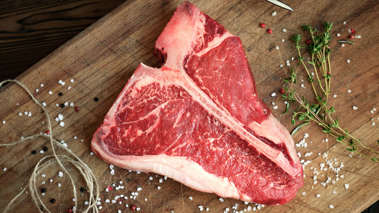 T-bone steak on wooden board