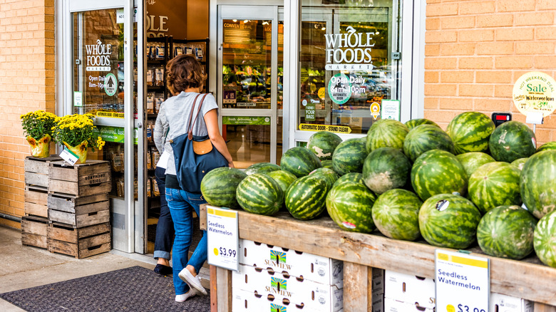 Woman walking into a Whole Foods store