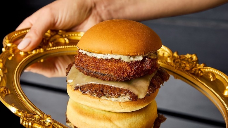 A Black Truffle Shack Stack from Shake Shack on a metallic platter.